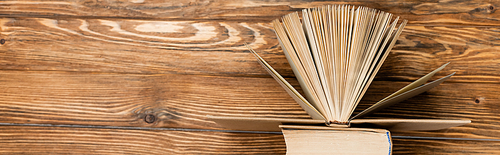 top view of books on wooden textured desk, banner