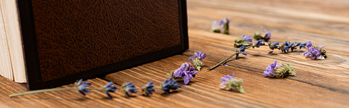 close up view of lavender flowers on wooden desk, banner