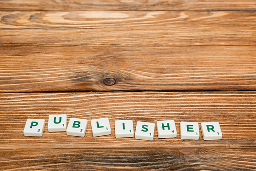 high angle view of white blocks with publish lettering on wooden surface with copy space