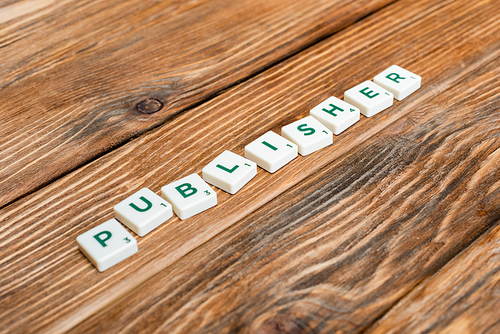 white blocks with publisher lettering and numbers on wooden desk