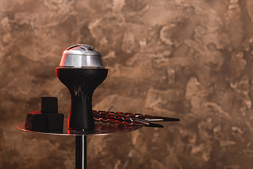 Coals on hookah on textured stone background