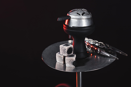 Coals on hookah with lighting isolated on black