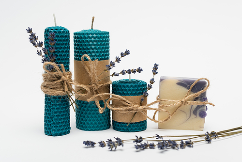 Handmade soap and candles with twine and lavender on white background