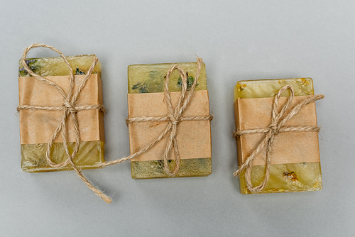 Top view of handmade soap on grey background