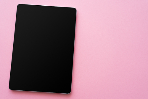 top view of digital tablet with blank screen on pink
