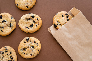 Top view of cookies and craft package on brown background