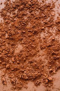 Top view of cocoa powder on brown background