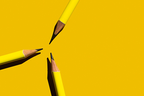 flat lay with sharp pencils on yellow background