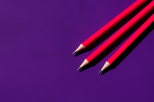 top view of sharp pencils on purple background