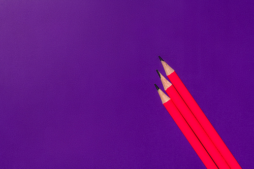 top view of pencils on purple background