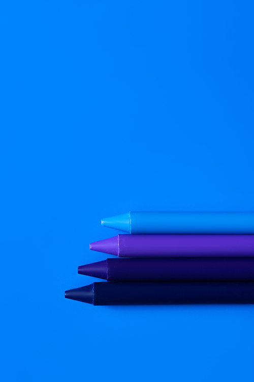 top view of blue gradient crayons on bright background