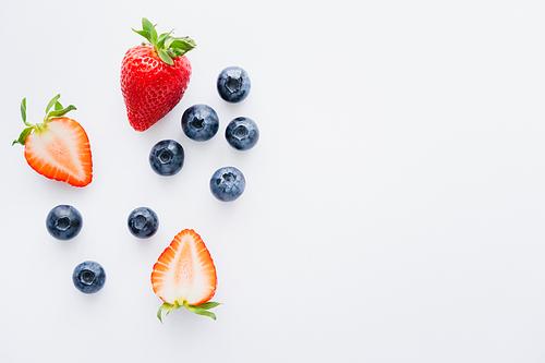 Top view of fresh berries on white background with copy space
