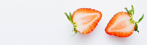Close up view of juicy cut strawberry on white background, banner