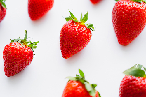 High angle view of ripe strawberries on white background