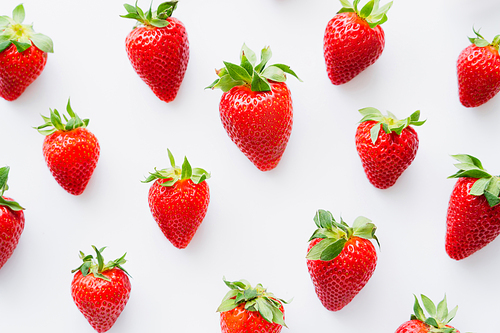 Flat lay with ripe strawberries on white background