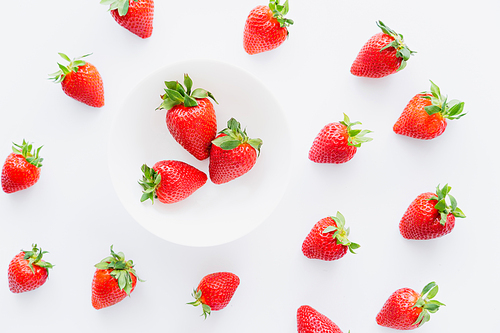 Flat lay with organic red strawberries on white background