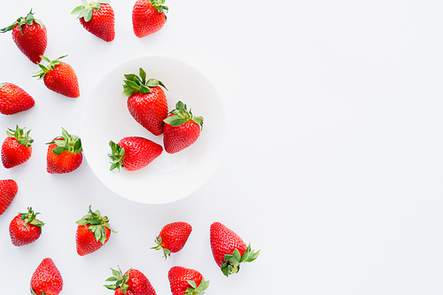 Top view of tasty strawberries in plate on white background