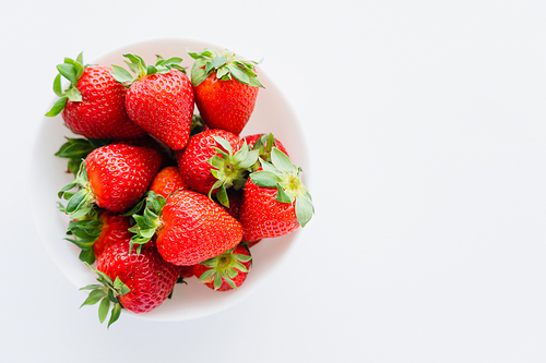 Top view of strawberries in bowl on white background