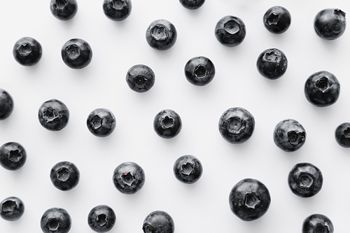 Flat lay of blueberries on white background
