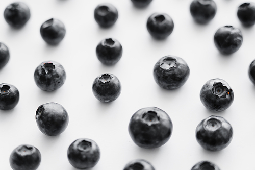 Close up view of fresh blueberries on white background