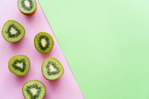 top view of fresh kiwi fruit on green and pink