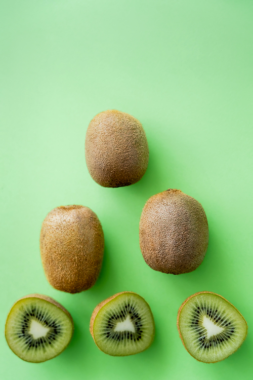 top view of organic kiwi fruit on green
