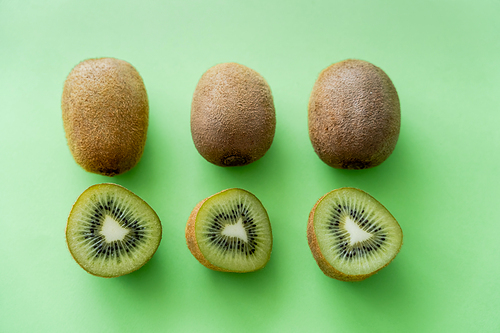 flat lay of organic kiwi fruit on green