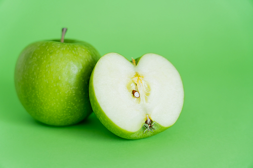 juicy and fresh apples on green background