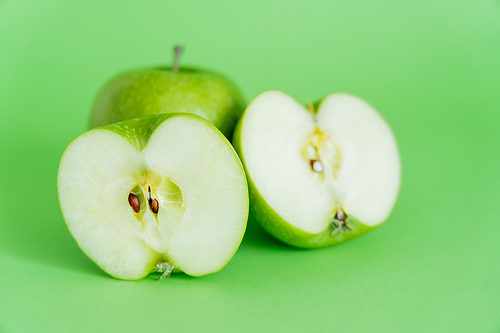 juicy and ripe apples on green background