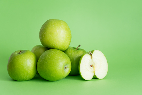 pile of delicious apples on green