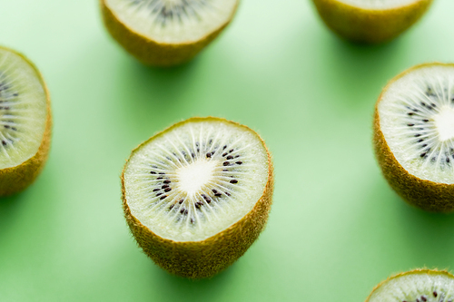 close up view of juicy fresh kiwi fruit on green