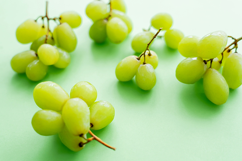 close up view of delicious grapes on green