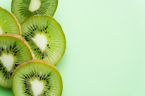 top view of sliced fresh kiwi on green