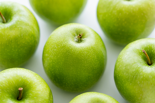 close up of delicious green apples on white