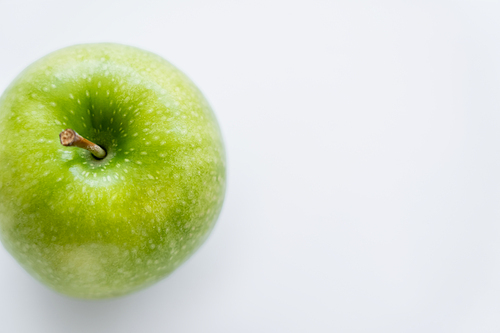 top view of whole green apple on white