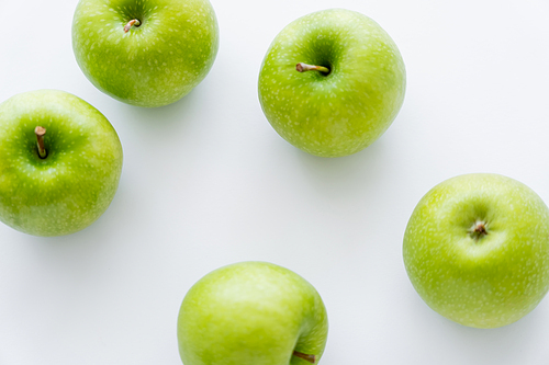 top view of green and ripe apples on white