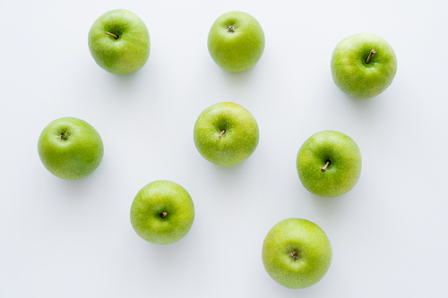 flat lay of green and ripe apples on white