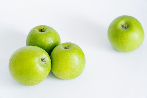 ripe and fresh green apples on white