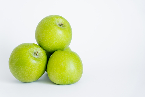 green and organic apples on white