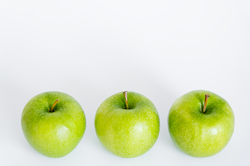 high angle view of green and ripe apples on white