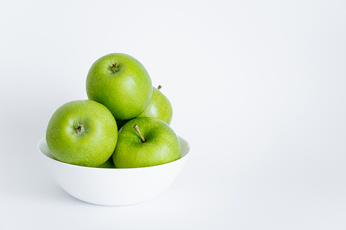 bowl with green and ripe apples on white