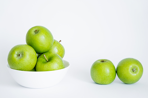 bowl with green and fresh apples on white