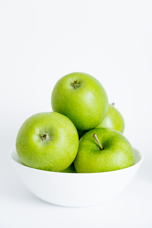 bowl with green natural apples on white