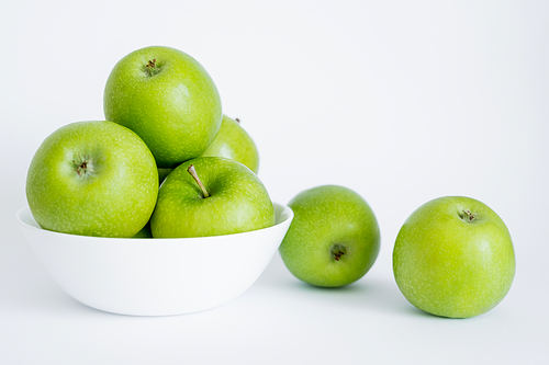 bowl with green and healthy apples on white