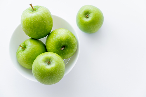 top view of ripe apples in bowl on white