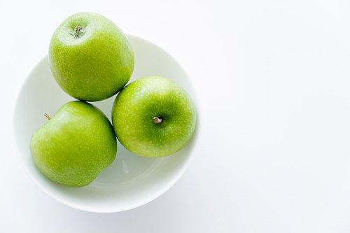 top view of fresh apples in bowl on white