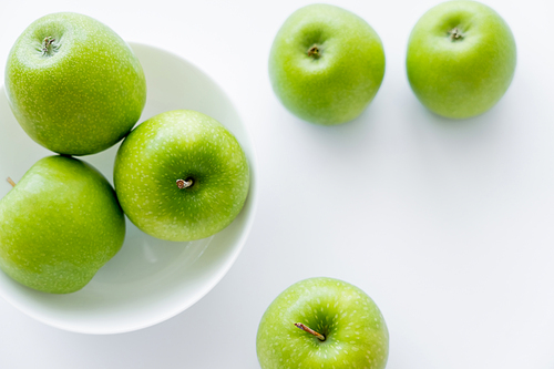 top view of juicy and ripe apples in bowl on white