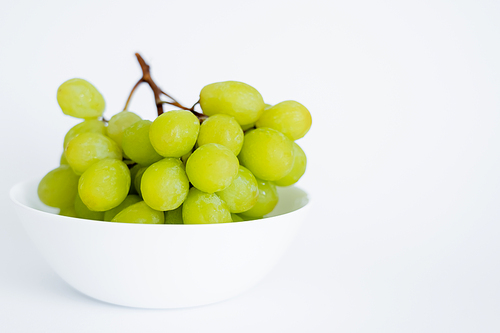 fresh and green grapes in bowl on white