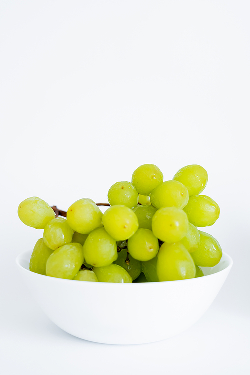 sweet green grapes in bowl on white