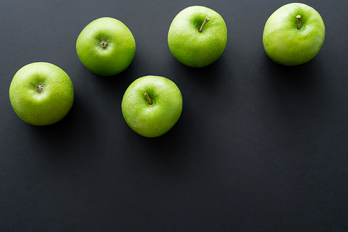 top view of fresh and green apples on black